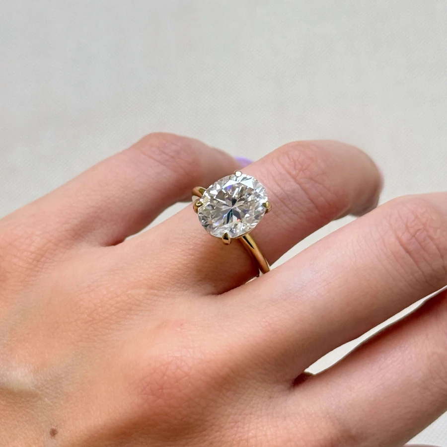 pierscionek-zareczynowy-royal-stones-moissanit-5ct-szlif-owalny-na-palcu-bok-zloto-paris-hariets.JPG