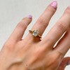 pierscionek-zareczynowy-bezel-moissanit-1-2ct-szlif-owalny-na-palcu-zolte-zloto-amora-hariets.jpg